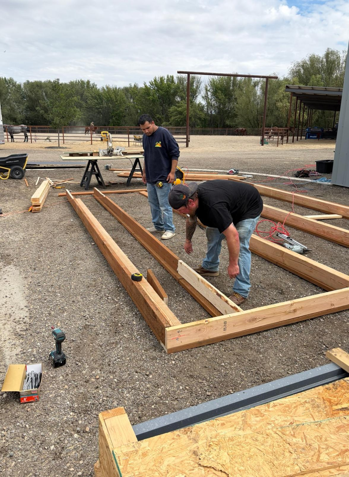 Builders assembling wood framing on site