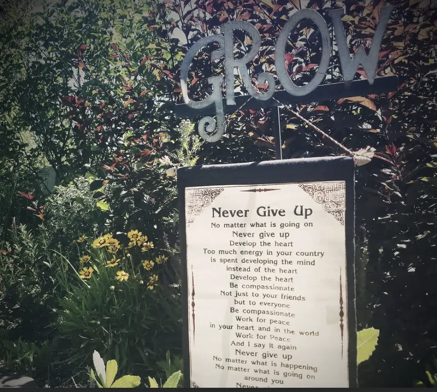 A garden sign and greenery at a project site